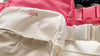 Beige, white, and pink fanny packs monogrammed with girl’s initials