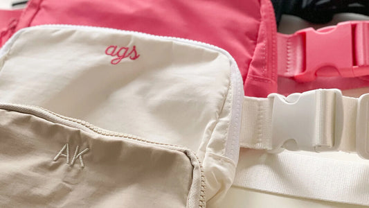Beige, white, and pink fanny packs monogrammed with girl’s initials