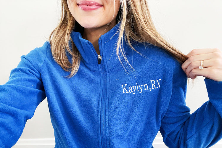 woman wearing embroidered fleece full zip with name and credentials embroidered on the left chest