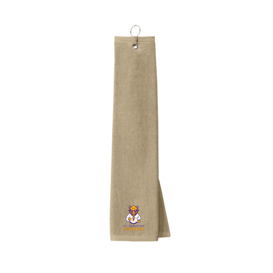 Beige towel with the st. timothy catholic school logo  embroidered along the bottom edge