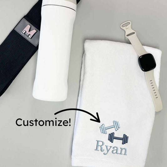 resistance band, water bottle, digital watch, and white gym towel with custom name embroidery and dumbbells icon