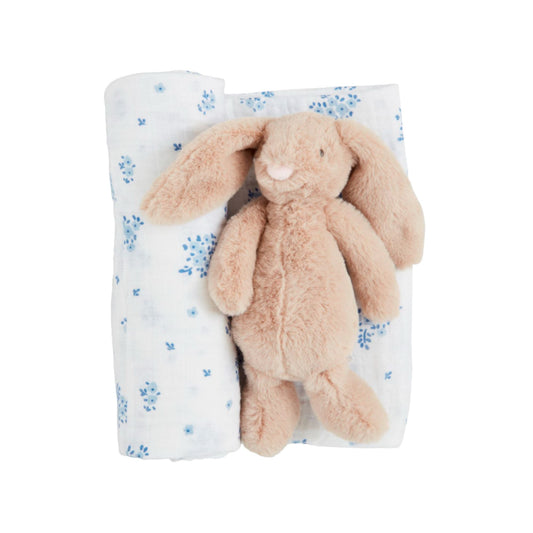 Plush bunny toy on a floral blanket with a white background