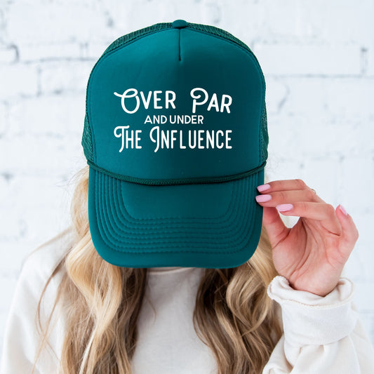 woman wearing a dark green hat with custom over par and under the influence design in white ink