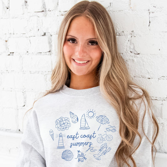 flower, seashell, sailboat, sun, umbrella, sunglasses, bicycle, lobster, wave, swimsuit, clam, lighthouse, ice cream and east coast summers script text printed on the middle text.