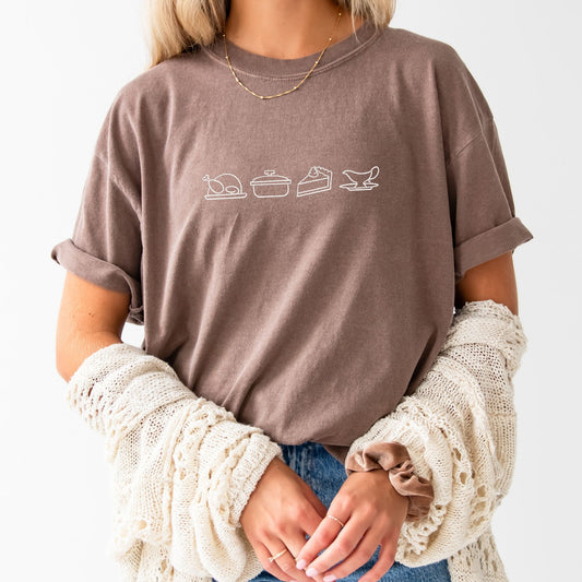 Young woman wearing an espresso brown comfort colors crewneck with custom thanksgiving embroidered icons