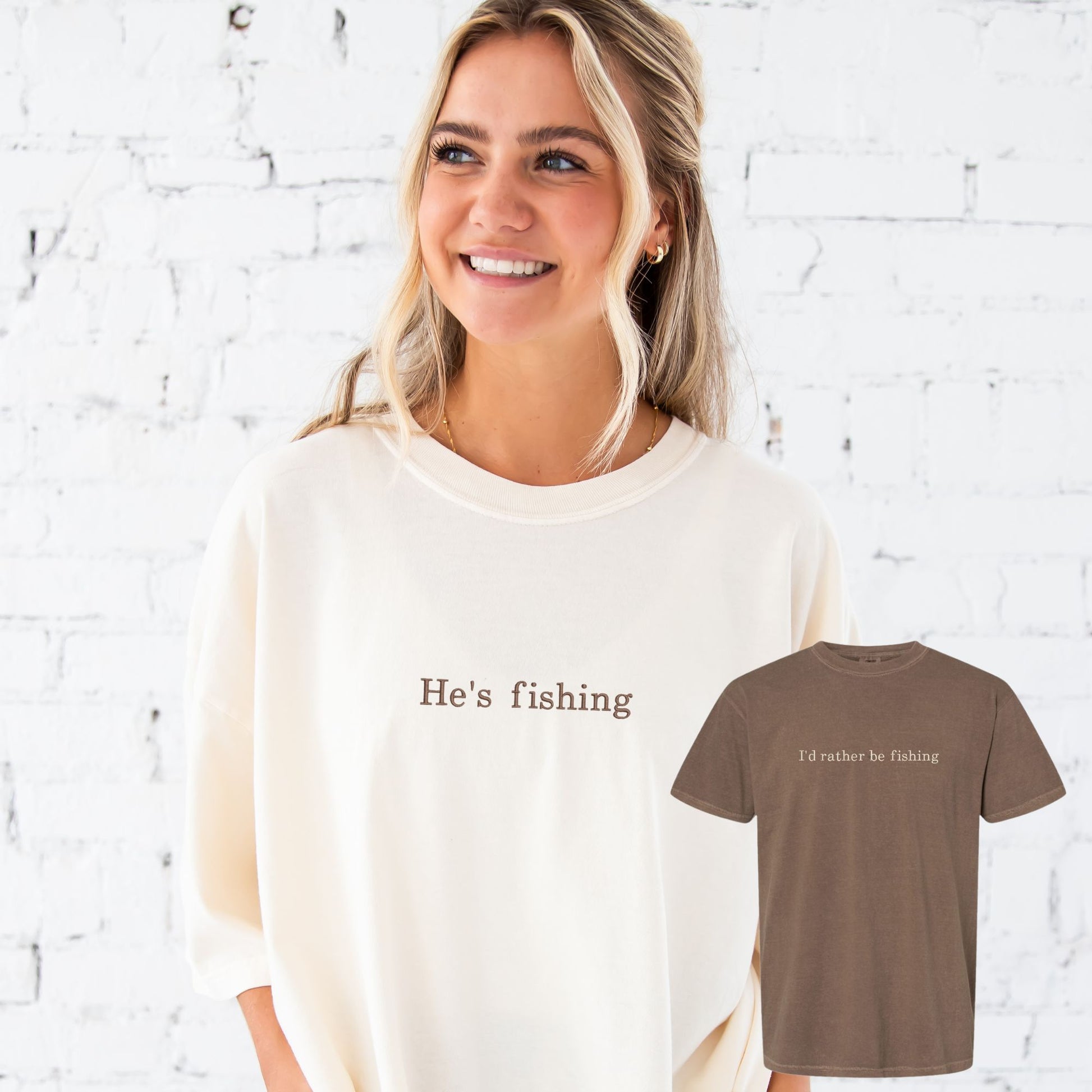 woman wearing a large ivory oversized comfort colors t-shirt with "he's fishing" embroidered in chestnut thread on the center chest and an espresso tee with "I'd rather be fishing" embroidered in natural thread on the center chest