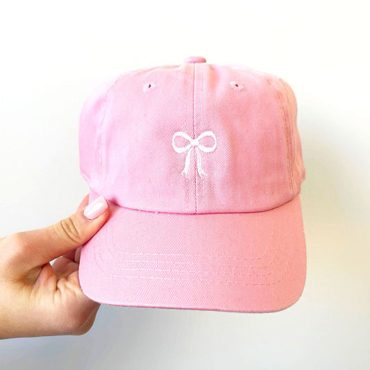 pink hat with a dainty white ribbon bow embroidered on the center