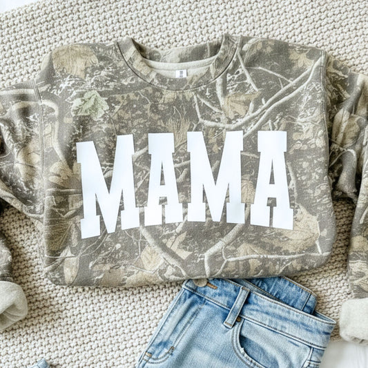 Camouflage sweatshirt with 'MAMA' text on a textured surface