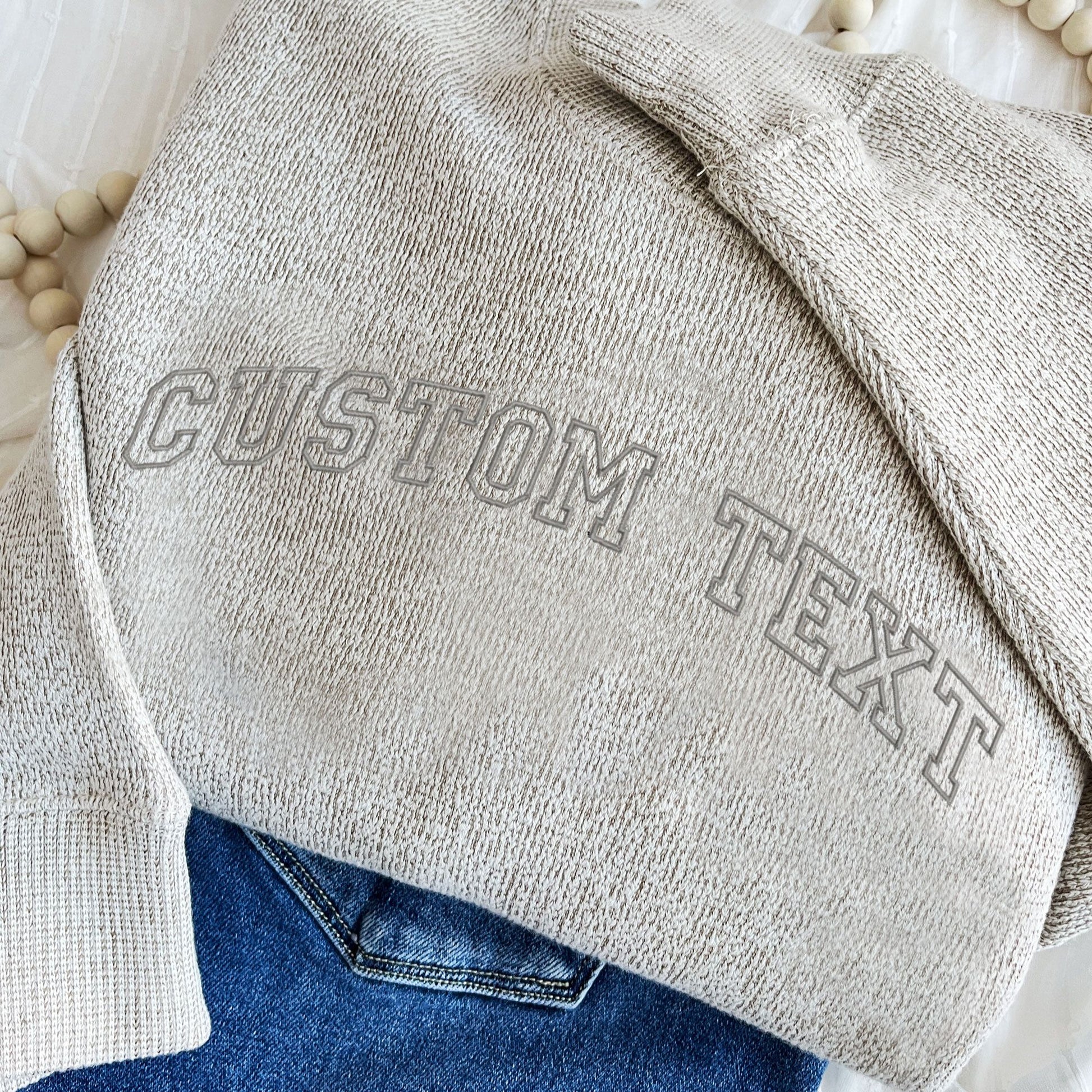 latte cozy knit crew with gray open athletic block custom text embroidered design across the chest