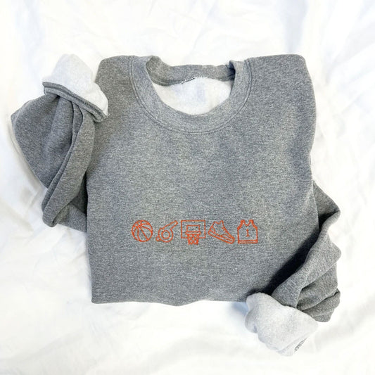 Gray sweatshirt with orange graphics on a white background