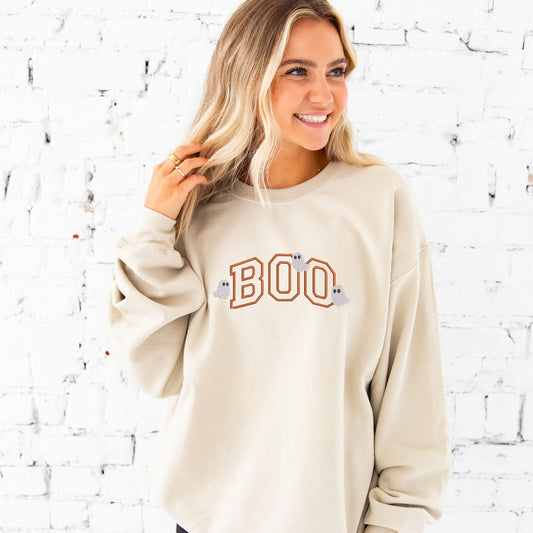 young woman wearing a Large Sand crewneck with embroidered Boo Pumpkin Spice thread and little ghost over the design