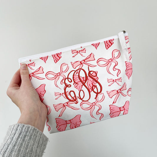 bow cosmetic pouch with custom monogram embroidery in red thread