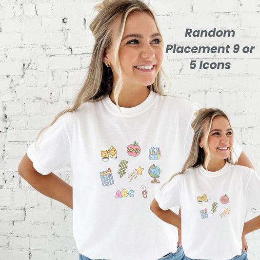 Two people wearing white comfort colors t-shirts with colorful teacher icons printed in a random pattern