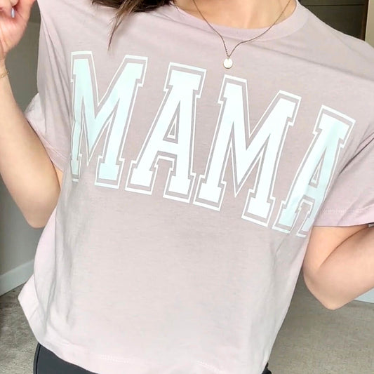 woman wearing a blush cropped t-shirt with custom printed mama design across the chest in white ink