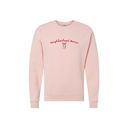 Pink sweatshirt with 'Neighborhood Barre' text on a white background