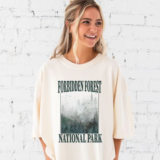 girl wearing an oversized ivory comfort colors t-shirt with a large distressed forbidden forest national park print