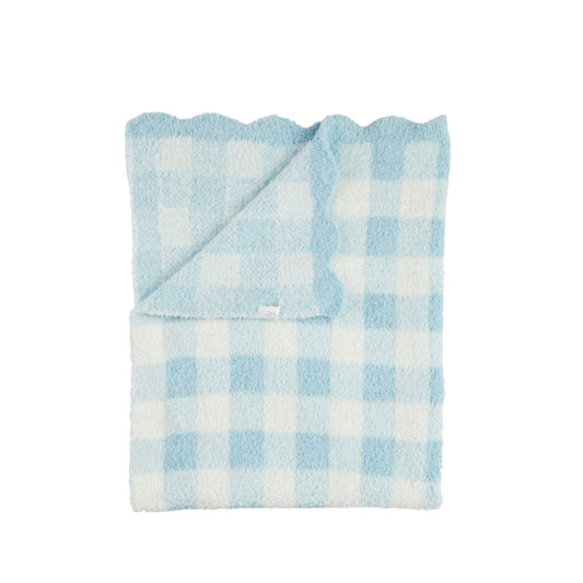 Folded blue and white checkered blanket on a white background