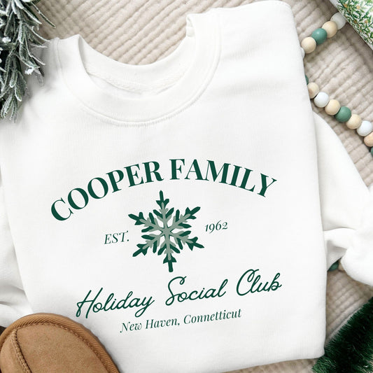 a custom print featuring a family name, Est date, snowflake, holiday social club, and location in green