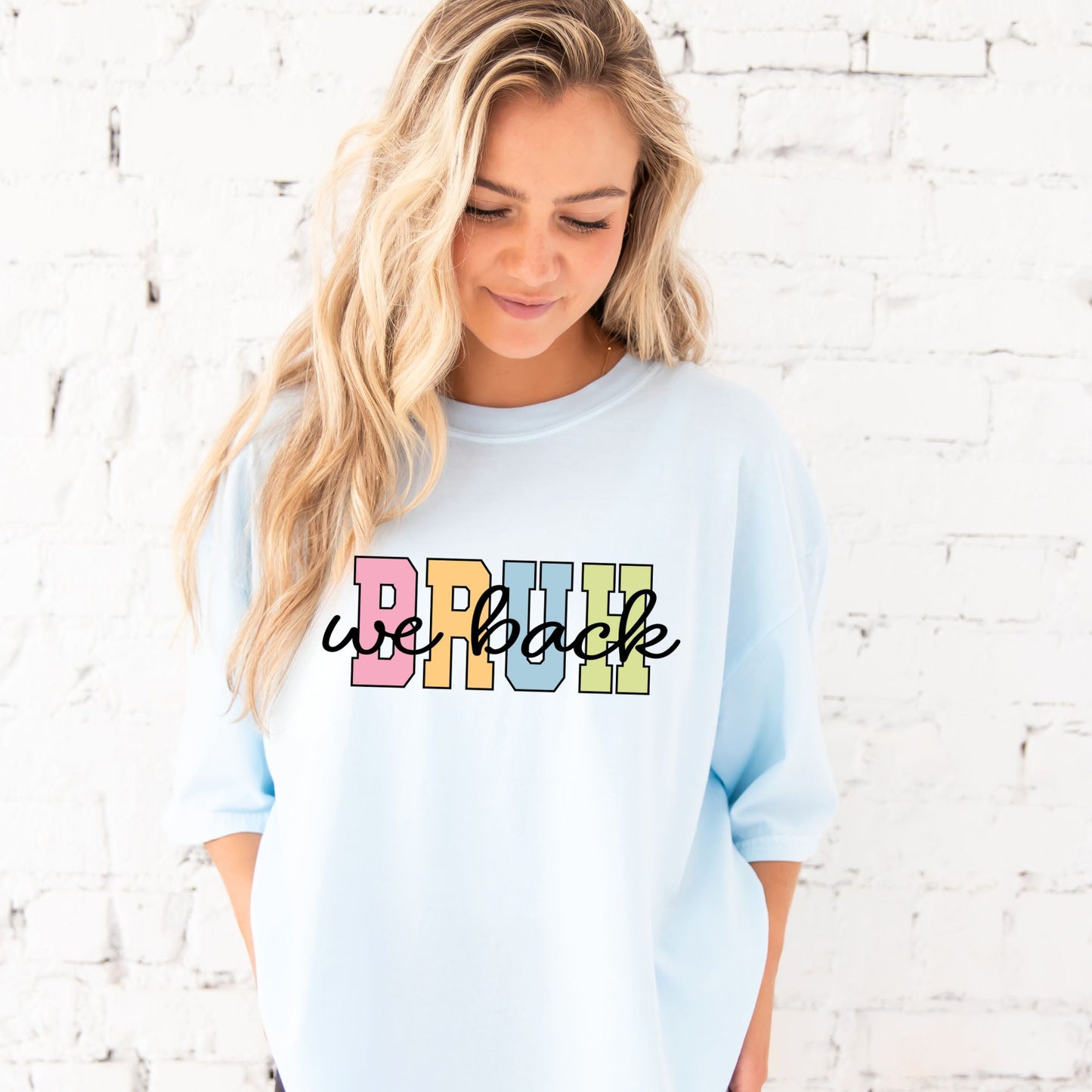 woman wearing an oversized chambray comfort colors t-shirt with custom bruh we back printed design