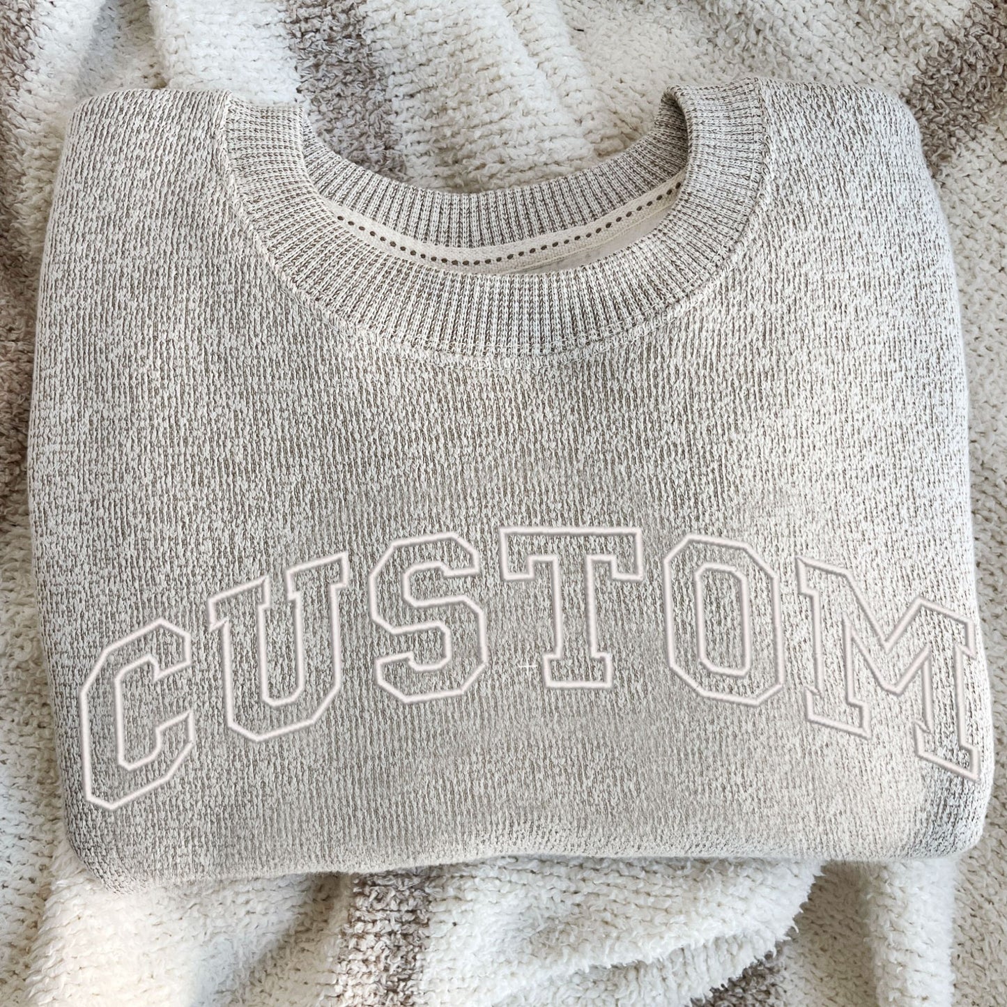latte cozy knit crew with white open athletic block custom embroidered design across the chest