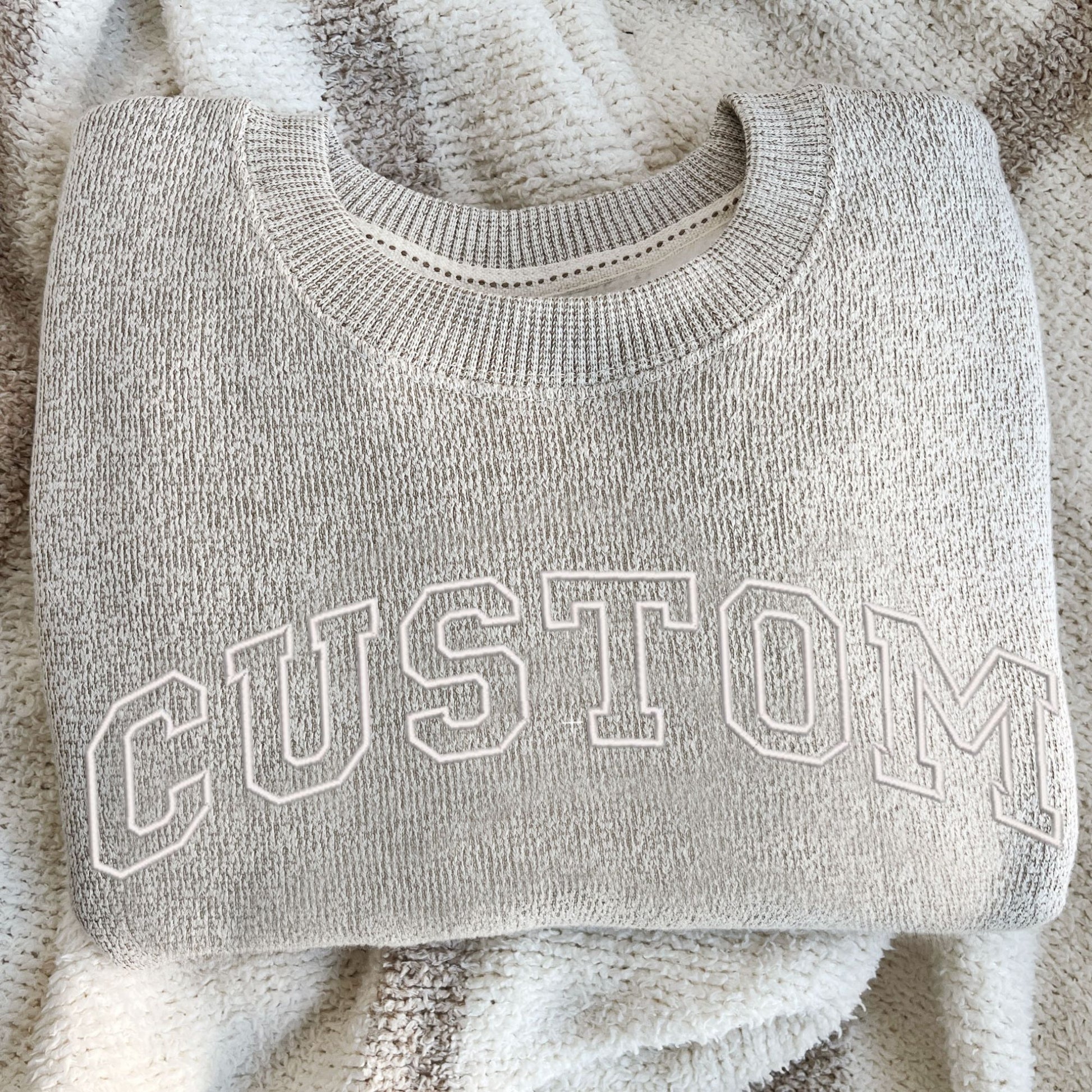 latte cozy knit crew with white open athletic block custom embroidered design across the chest