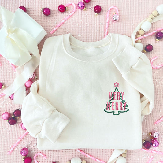 sweet cream crewneck with custom very merry and outlined tree embroidered design