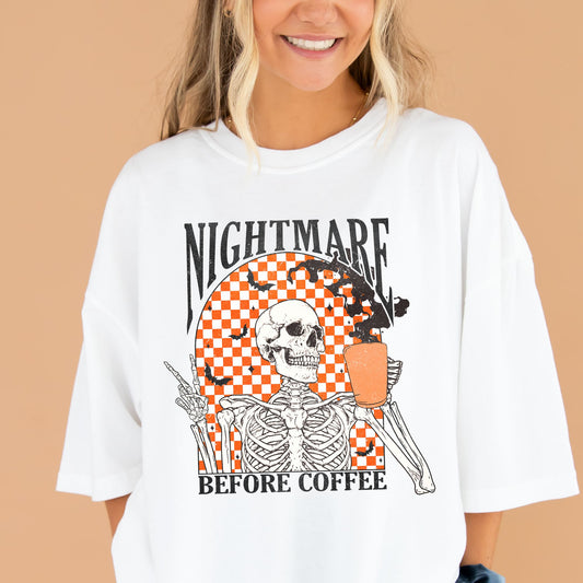 young woman wearing a white comfort colors t-shirt with a nightmare before coffee skeleton/bat print with a checkered background