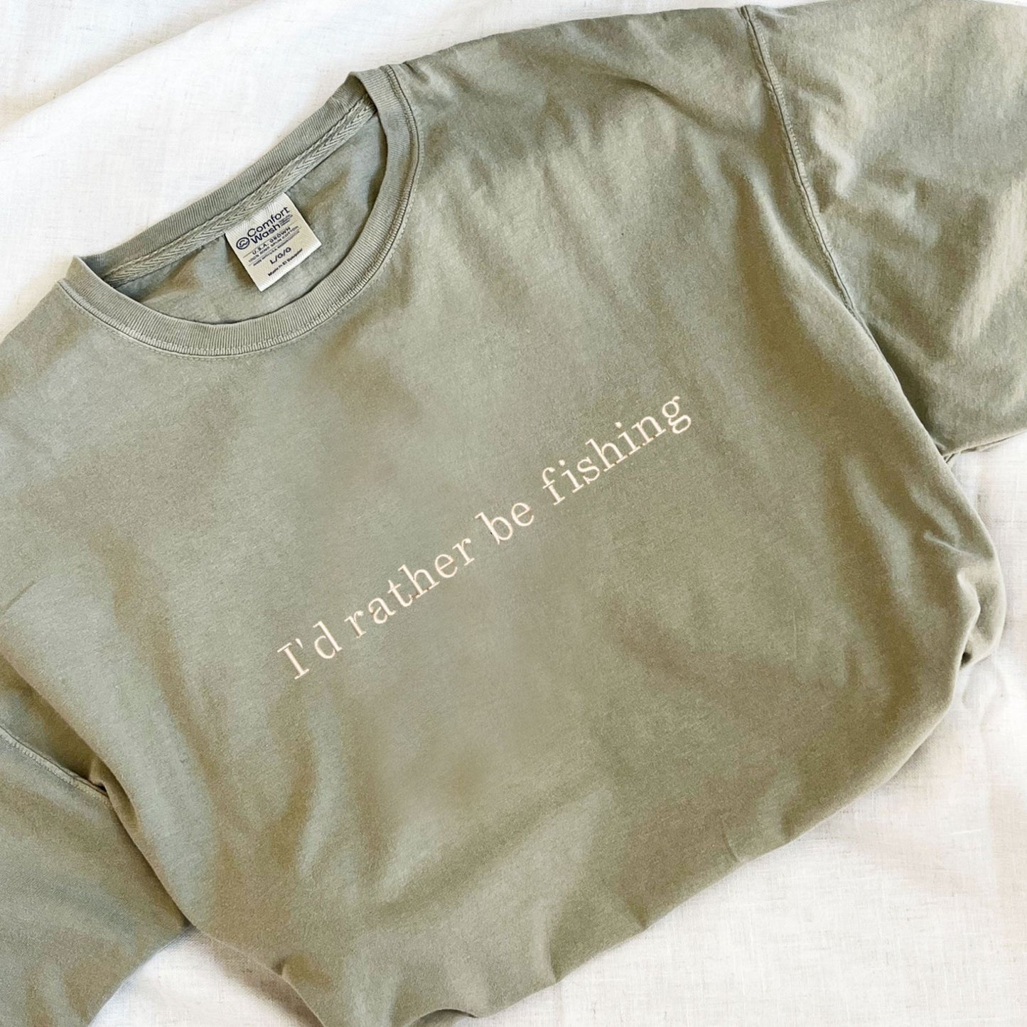 Bay comfort colors tee with "I'd rather be fishing" embroidered in natural thread on the center chest