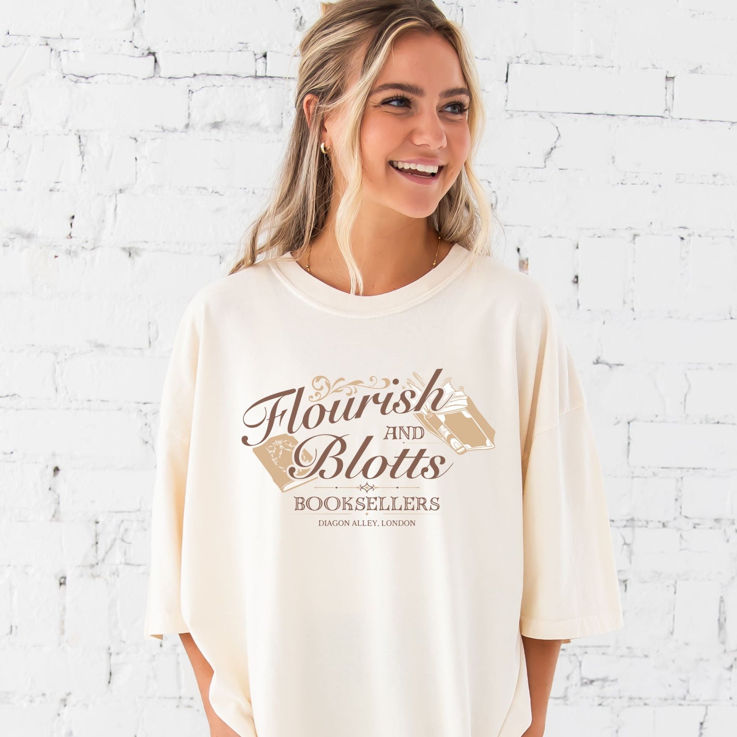 girl wearing an oversized ivory comfort colors t-shirt with a Flourish and Blotts booksellers printed design