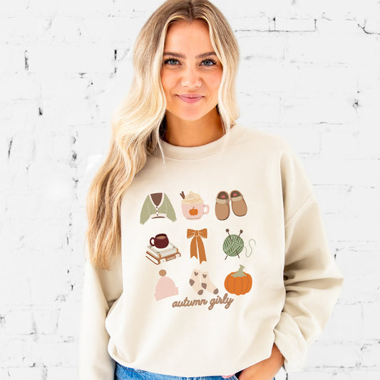 girl wearing a sand crewneck sweatshirt with cozy, autumn girly fall icons printed in a grid style, including the following: sweater, pumpkin spice, slippers, books, bow, yarn, hat, socks, pumpkin