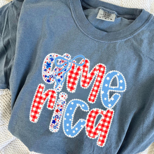a blue jean comfort colors t-shirt with coquette bow lace america floral and gingham print on the center chest