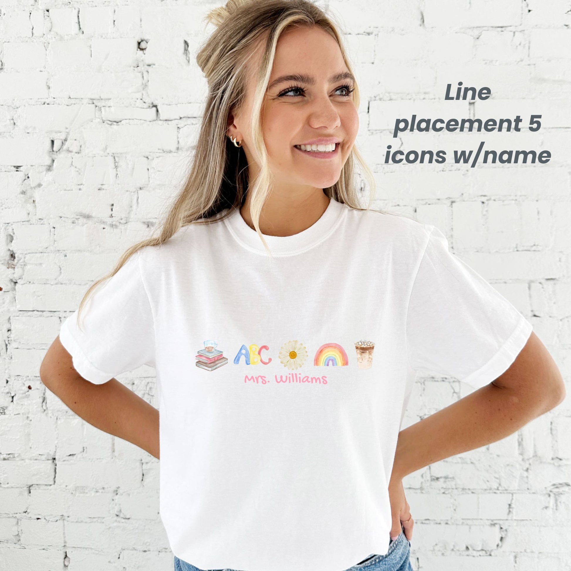 woman standing in front of a white brick wall wearing a white comfort colors tank top with cute watercolor teacher icons in a line with a name underneath printed on the center chest