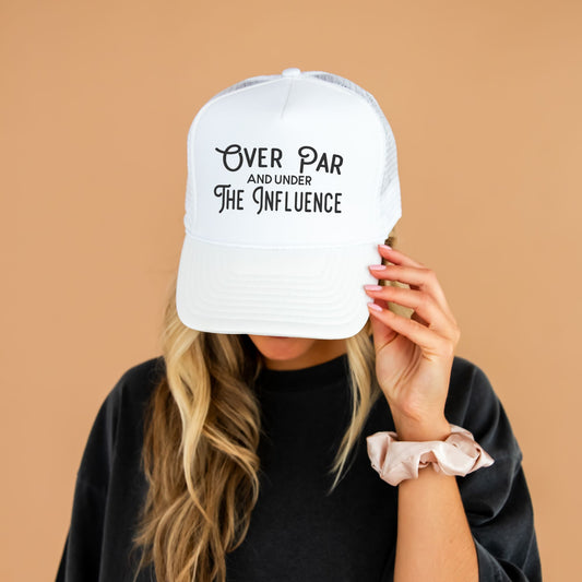 woman wearing a dark green hat with custom over par and under the influence design in white ink