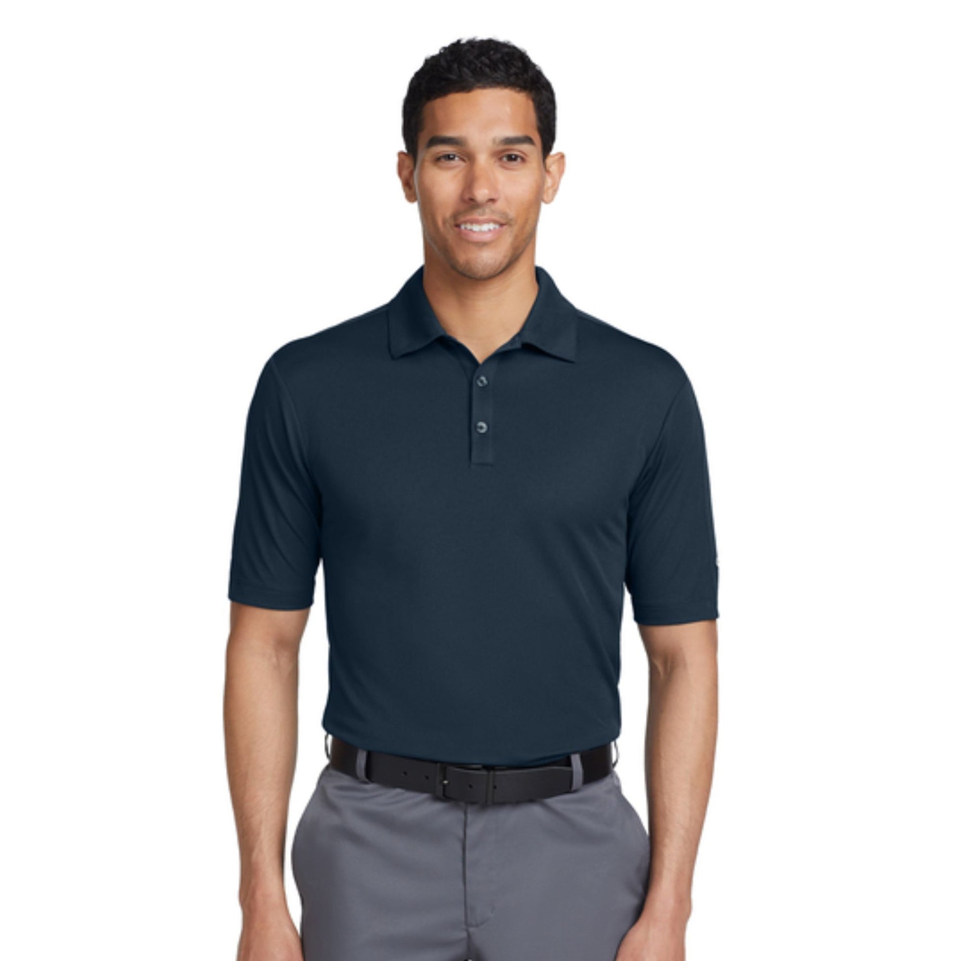 Man wearing a navy polo shirt and gray pants on a white background