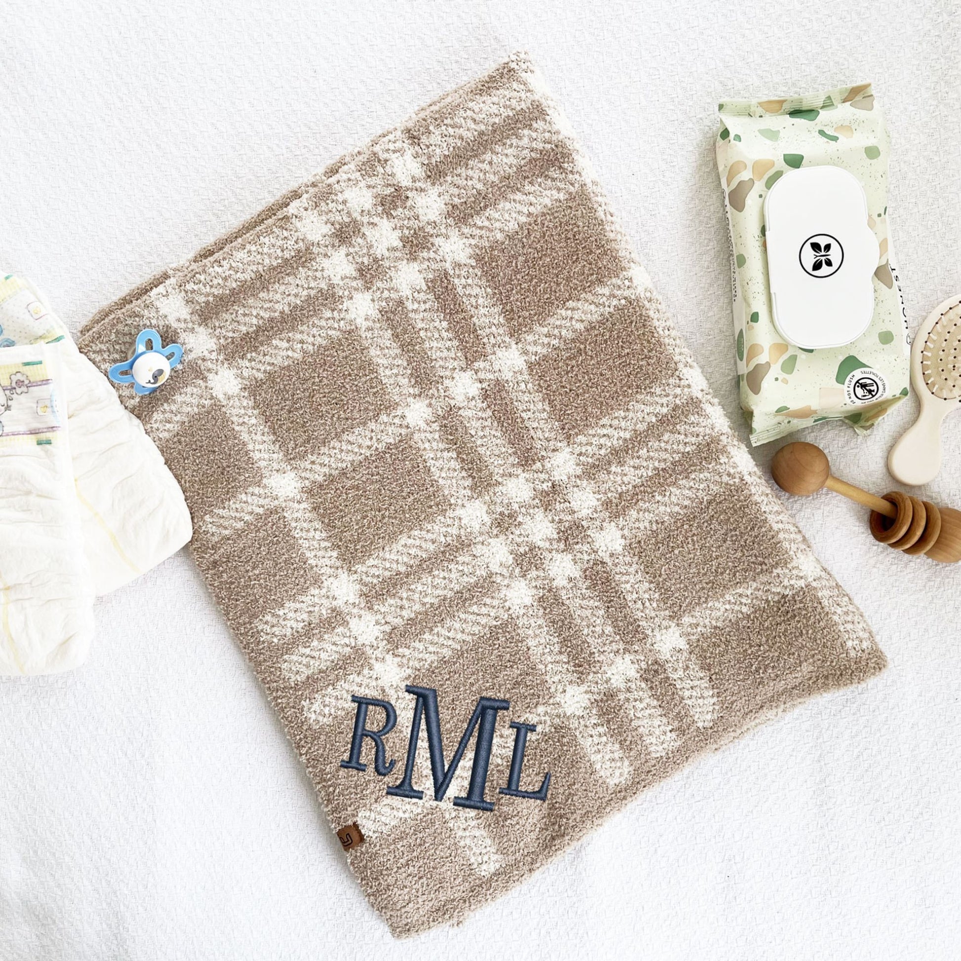 ultra soft cream and tan plaid baby blanket with custom monogram embroidered on the corner in font 8 with navy thread