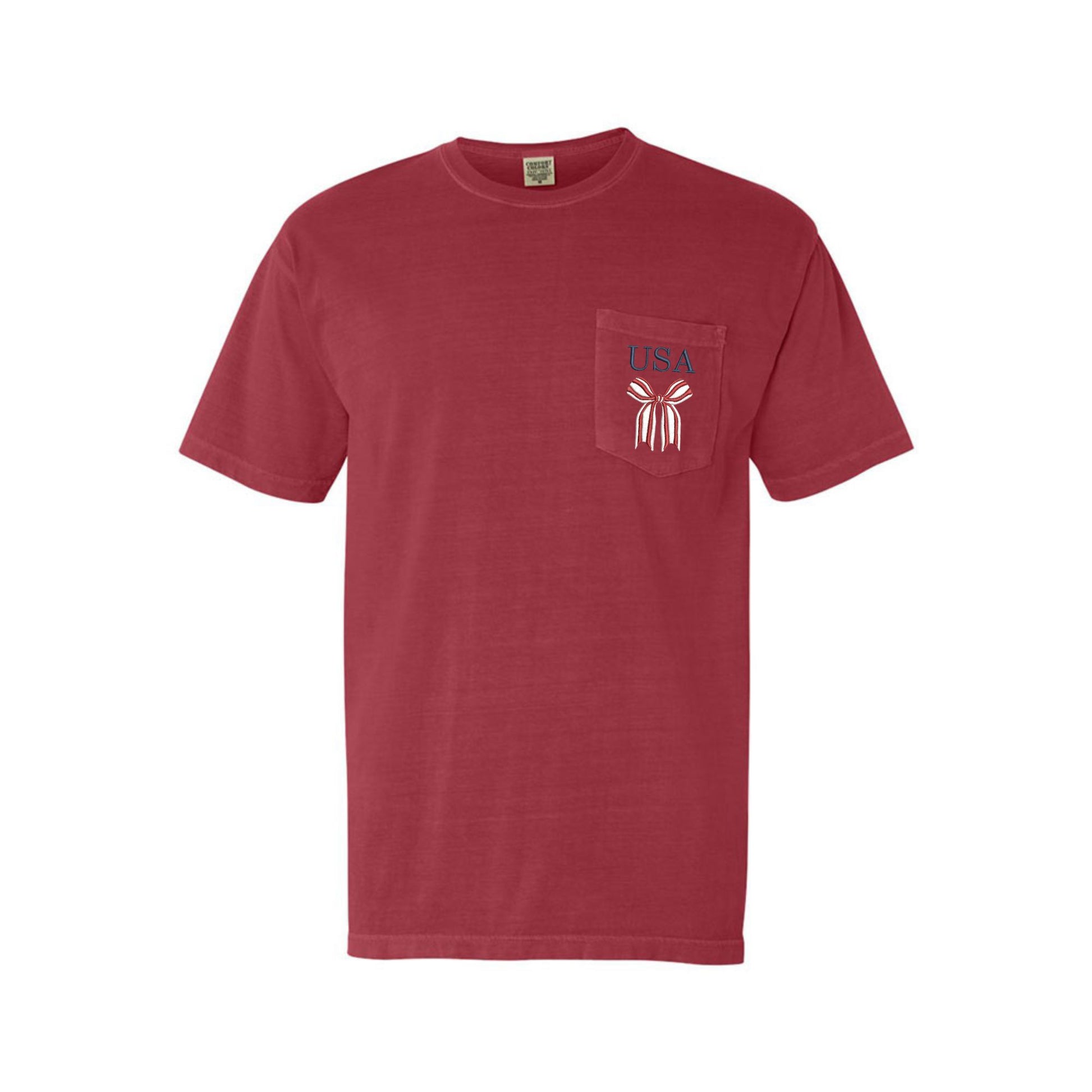 crimson comfort colors pocket tshirt with embroidered red and white striped bow and USA in navy above the bow embroidered on the pocket