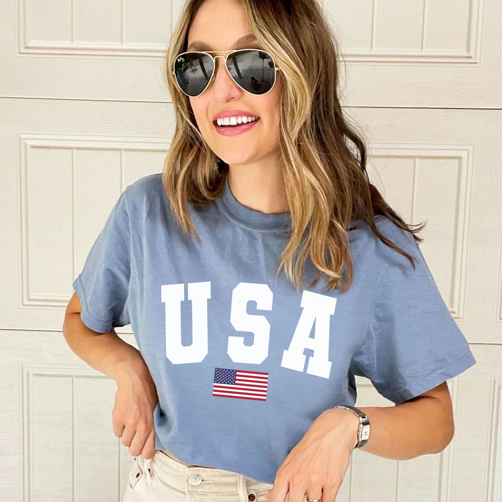woman wearing a blue jean comfort colors t-shirt with usa american flag printed design