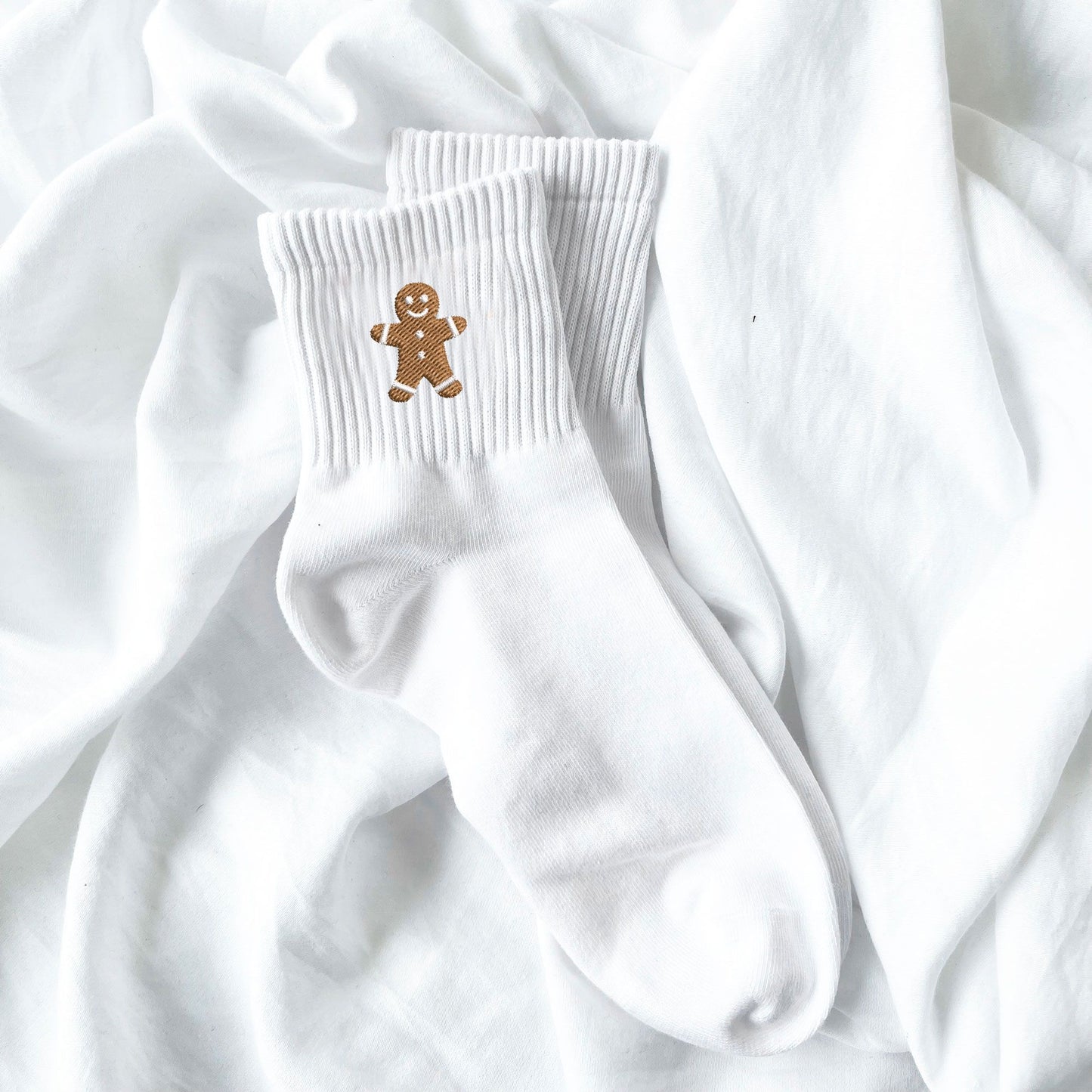 white crew socks with embroidered gingerbread man design