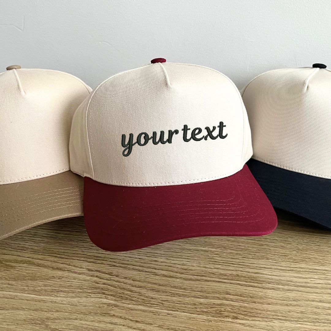 two toned canvas and red hat with custom embroidered text in black thread