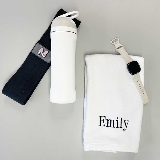 water bottle, weight band, watch, and white gym towel with custom name embroidery