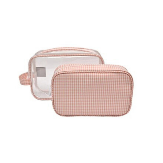 Pink checkered toiletry bag with clear compartment on a white background