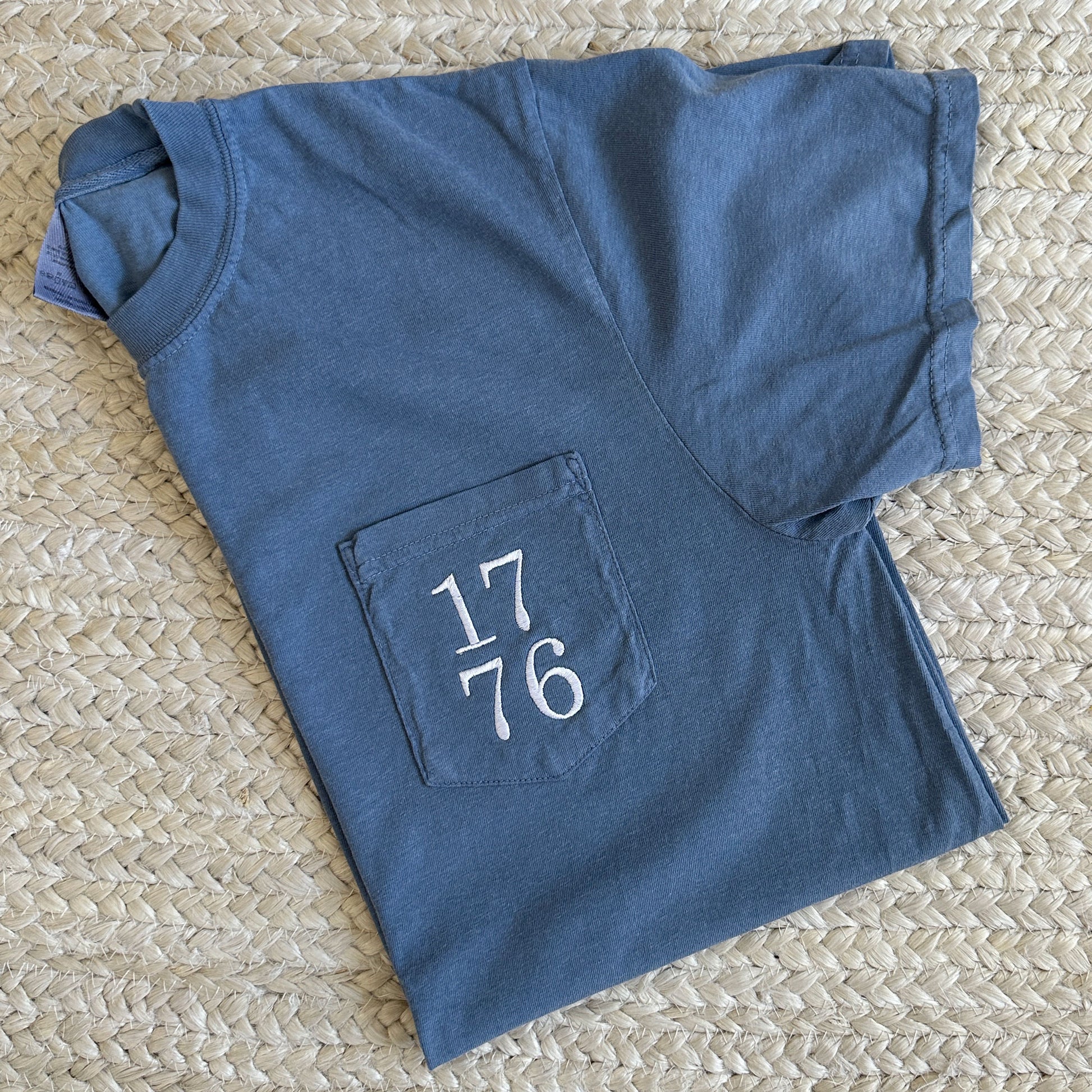 blue pocket tee with 1776 embroidered stacked design