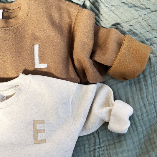 coyote brown and heather oatmeal toddler crew with a custom single letter embroidered design on the left chest