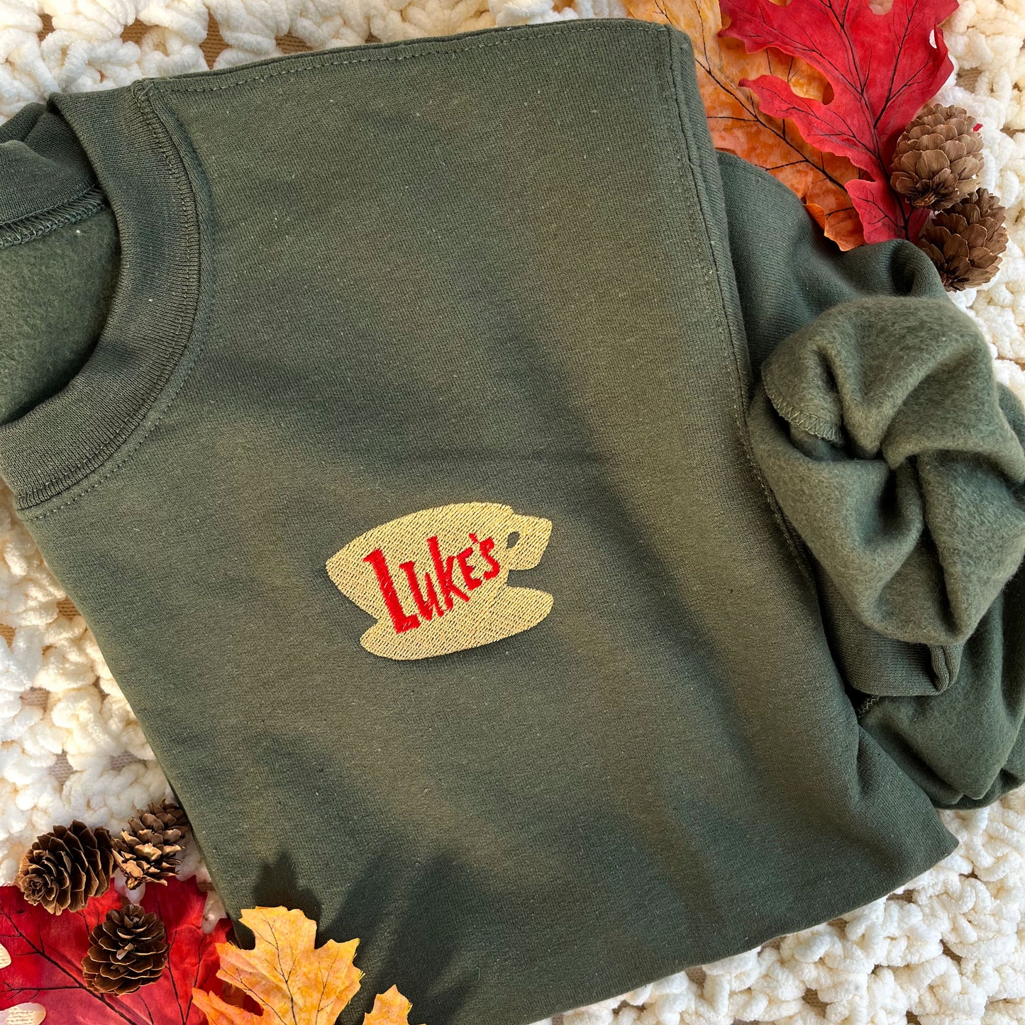 military green crewneck sweatshirt with a Luke's diner embroidered logo