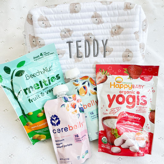 Children's travel pouch with cute teddy bear quilted pattern and custom embroidered name with snacks styled around it