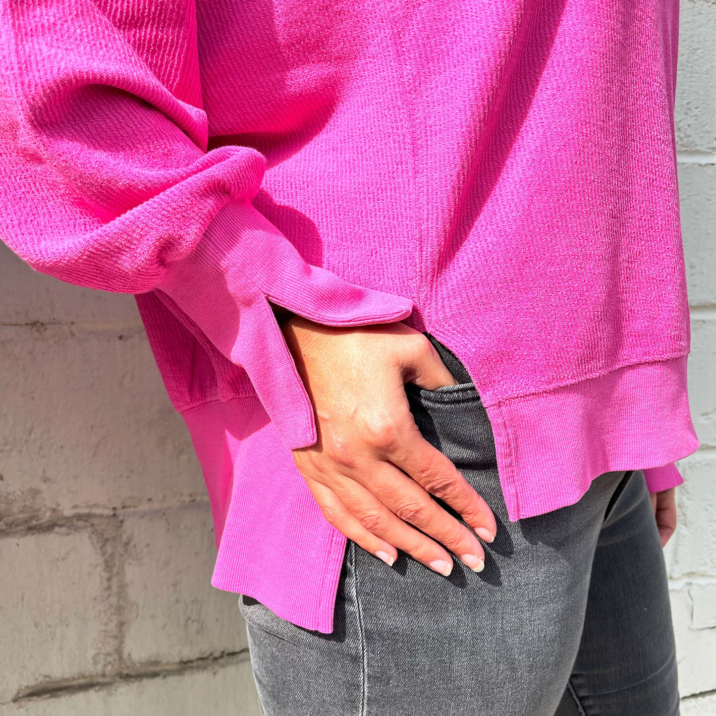 close up of the split hem and cuff on the ribbed pinkberry crewneck sweatshirt