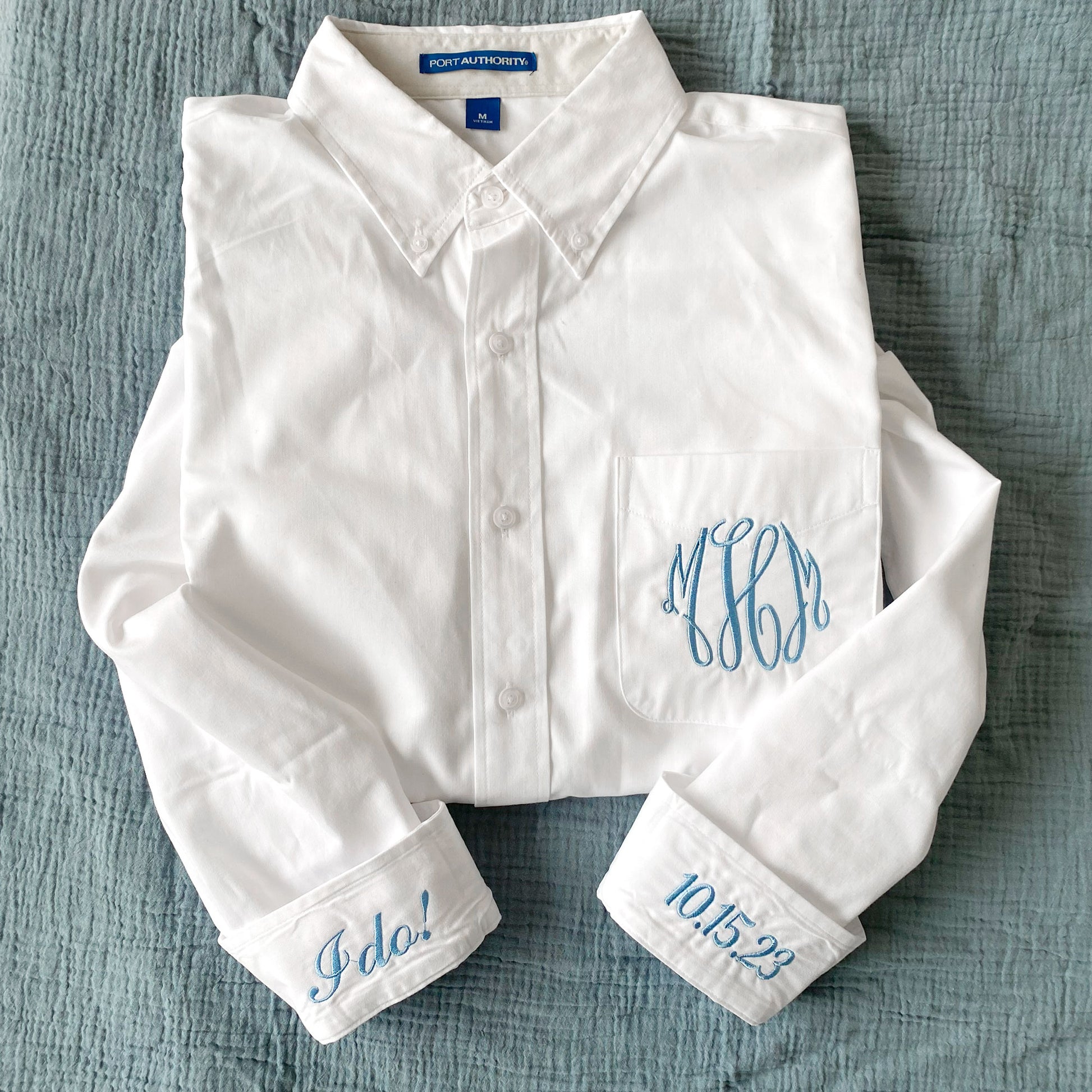 white button down with monogram and cuff embroidery in baby blue thread