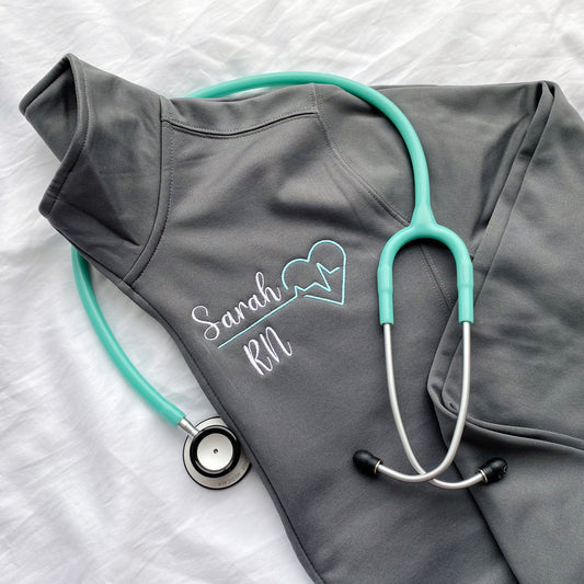 grey cadet collar full zip polyester jacket with a custom name and heartbeat embroidered design on the left chest.