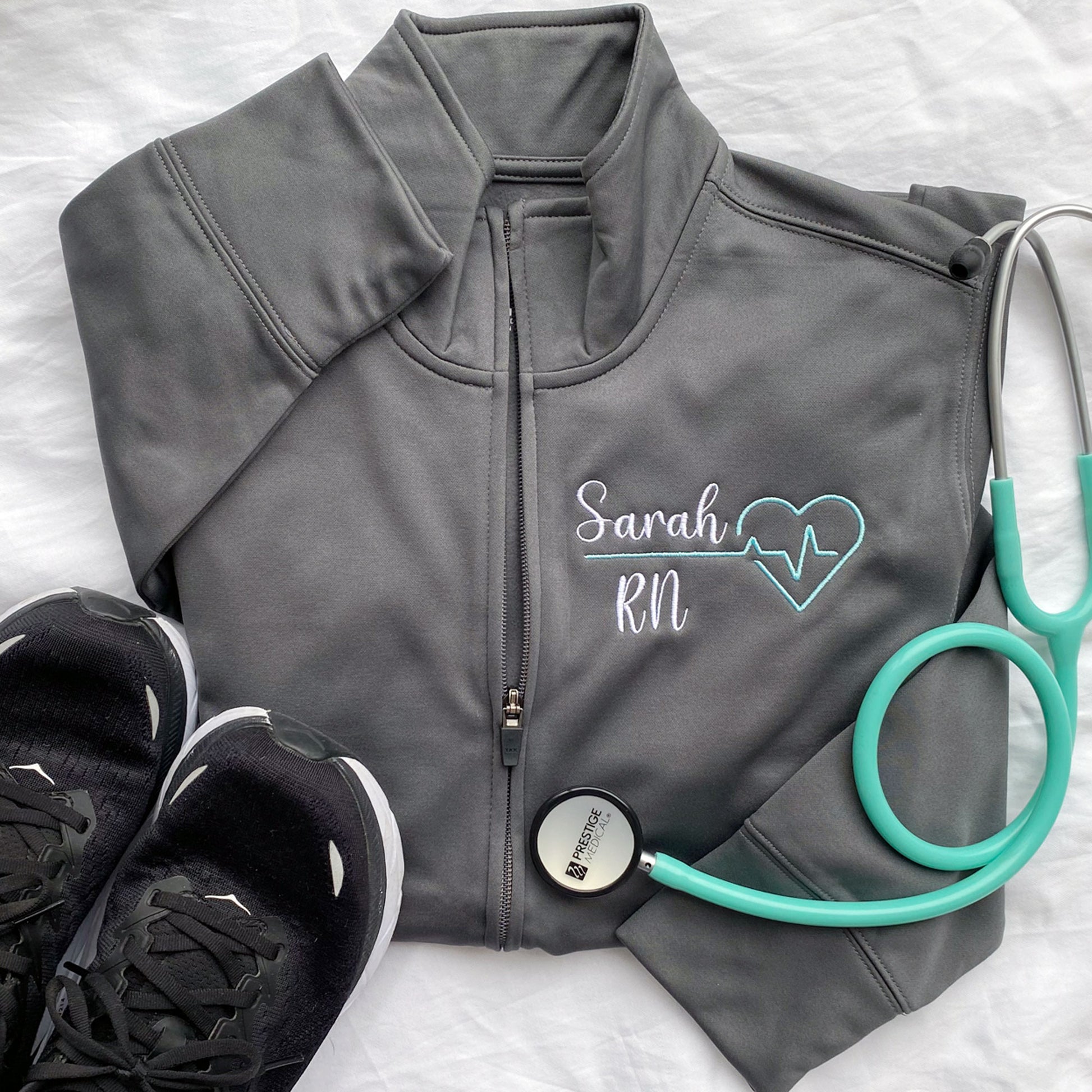 grey polyester fleece full zip jacket with custom medical design and name embroidery