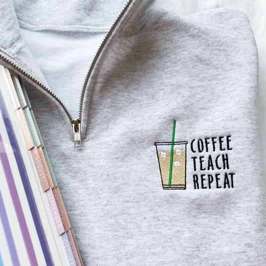 ash quarter zip pullover with a custom iced coffee, coffee teach repeat embroidered design on the left chest